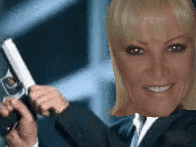 a woman in a suit is holding a gun
