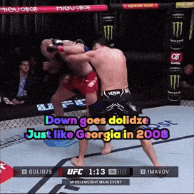 two men are fighting in a boxing ring with the words down goes dolidze just like georgia in 2008