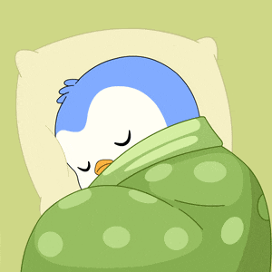 a blue and white penguin wrapped in a green polka dot blanket
