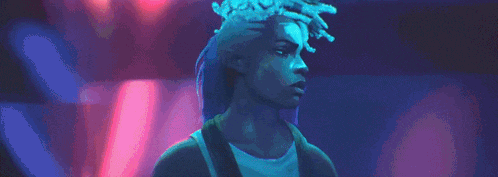 a woman with dreadlocks and a crown on her head is standing in front of a pink and blue background .