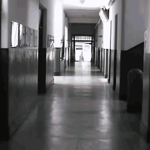 a long hallway in a building with a sign on the wall that says ' a '