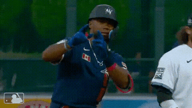 a baseball player is wearing a helmet and gloves while standing on the field .