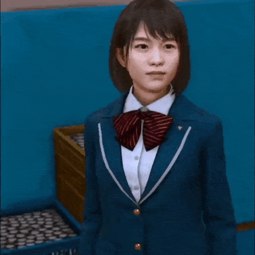 a girl in a school uniform is talking on her cell phone .
