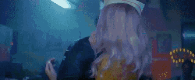 a man and a woman are hugging each other in a room in a restaurant .