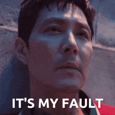 a man leaning against a wall with the words " it 's my fault " written above him