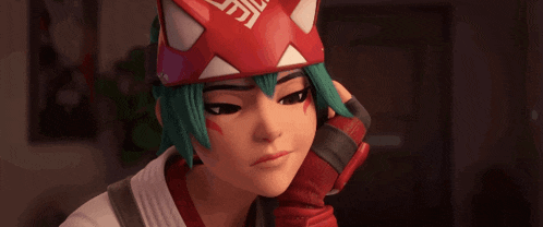 a girl with green hair is wearing a red and white mask with a chinese symbol on it