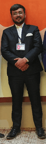 a man in a suit has a lanyard around his neck that says o.m.c.