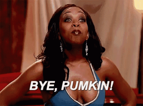 a woman is blowing a kiss and saying bye pumpkin .