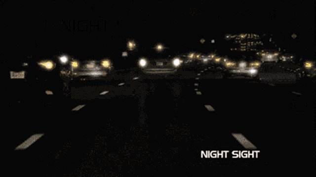 a pair of night sight glasses shows a car driving down a highway