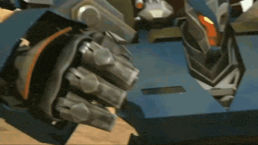 a close up of a robot 's fist with a glove on .