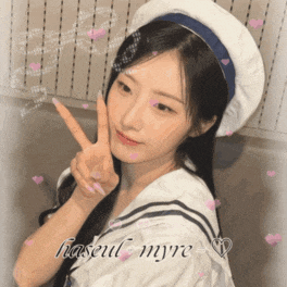 a girl giving a peace sign with the name haseul myre written on the bottom