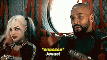 a man and a woman are sitting next to each other and the man is saying " sneezes jesus " .