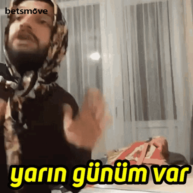 a man with a scarf around his head and the words yarn gunum var on the bottom