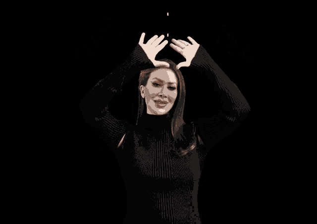 a woman in a black sweater stands in front of a black background that says insta fan