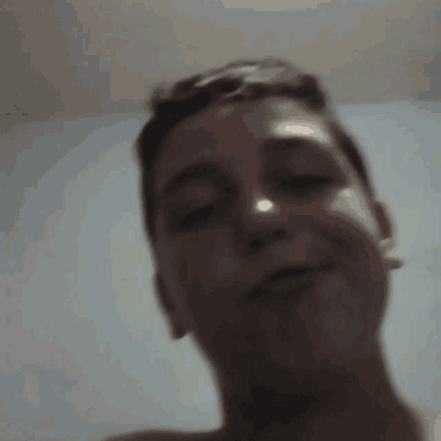 a close up of a boy 's face with a blurred background