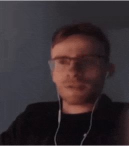 a man wearing glasses and headphones is making a funny face .