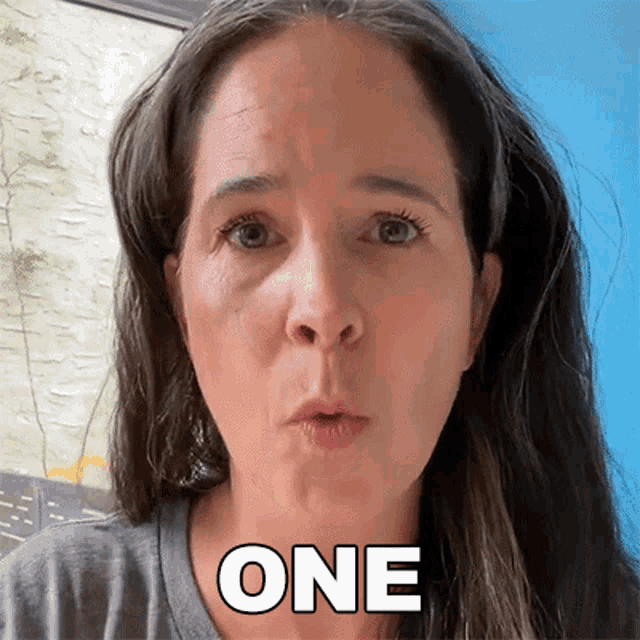 a close up of a woman 's face with the word one on her face .