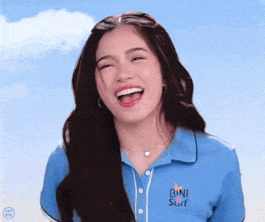a woman wearing a blue shirt with the word bani surf on it