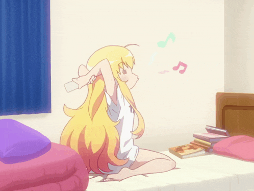 a girl with long blonde hair is sitting on a bed with her arms outstretched