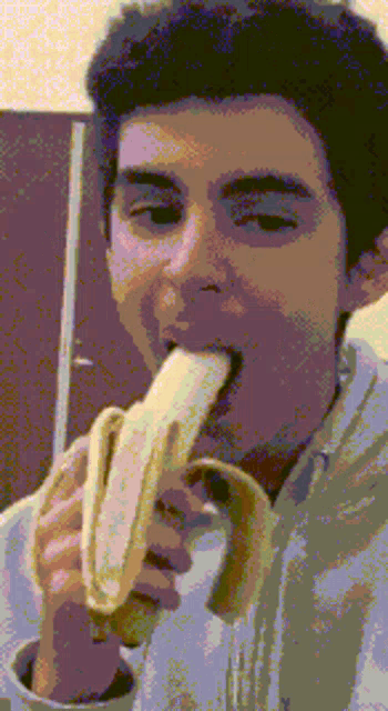 a man is eating a banana in a pixelated photo
