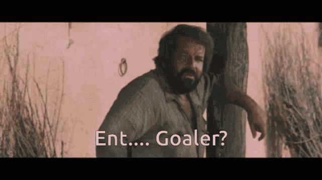 a man with a beard is leaning against a tree with the words ent goaler below him