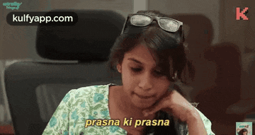 a girl wearing sunglasses says prasna ki prasna on the screen