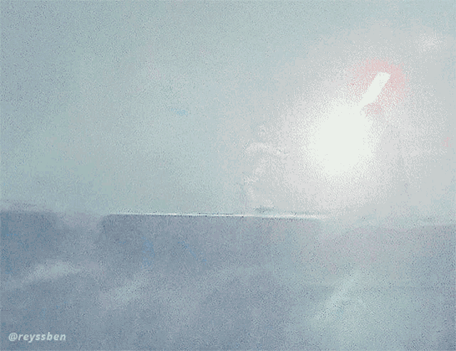 a man holding a light saber stands next to another man