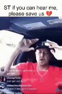 a man in a red shirt is sitting in a car with a broken heart on the bottom
