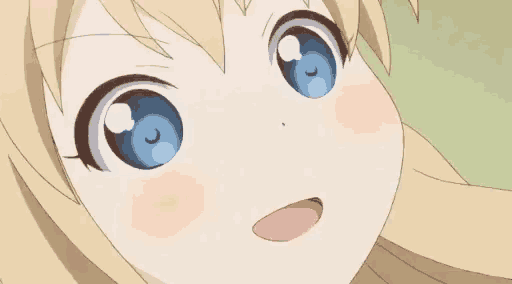 a close up of a girl 's face with big blue eyes