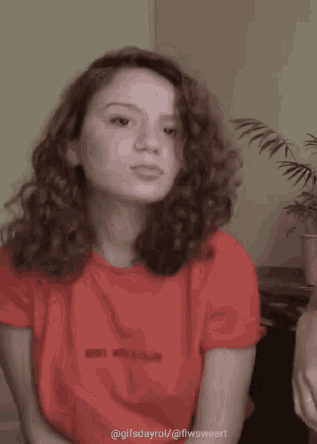 a woman wearing a red shirt that says rebel with a cause on it