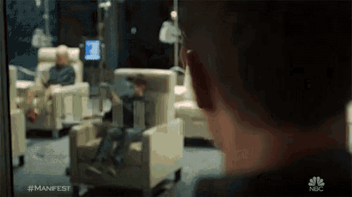 a blurred image of a man in a hospital room with the hashtag #manifest
