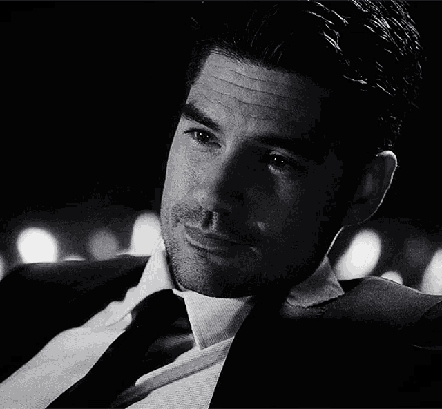 a man in a suit and tie is looking down