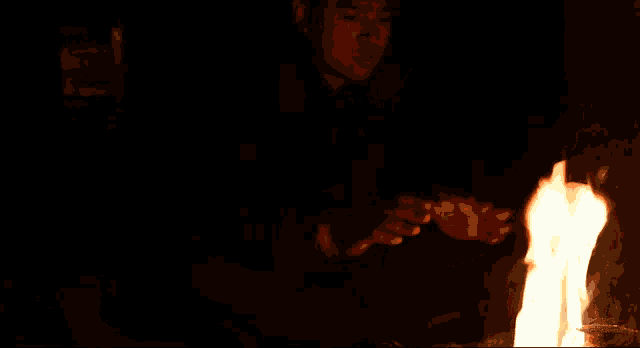 a man is holding a fire in his hands
