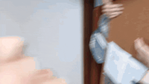 a blurry picture of a person holding a pillow in front of a mirror .