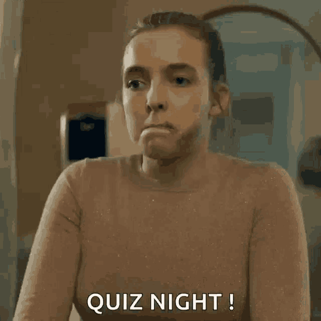 a woman is making a funny face and saying quiz night !