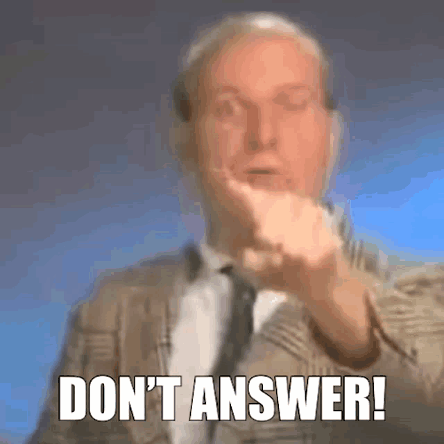 a man in a suit and tie is making a gesture with his hand and the words `` do n't answer '' .