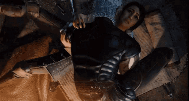 a woman in a black jacket is laying on a man 's lap