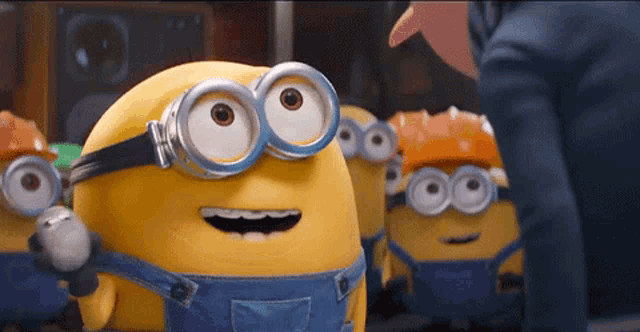a group of minions wearing hard hats and goggles standing next to each other