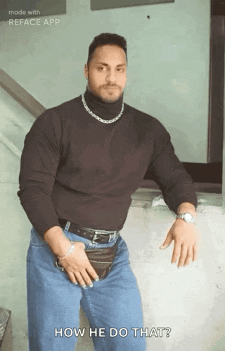 a man wearing a black turtleneck and blue jeans is standing in front of a wall and asking how he do that