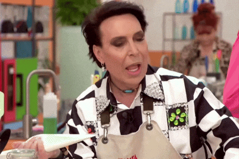 a woman wearing a black and white checkered shirt and apron