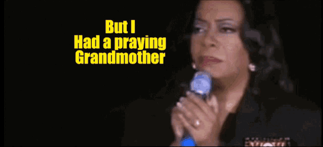 a woman singing into a microphone with the words but i had a praying grandmother