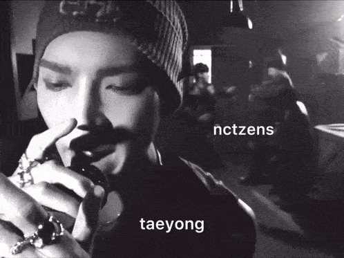 a black and white photo of taeyong with nctzens written on the bottom