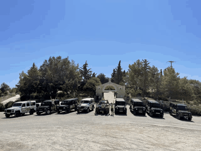 a row of jeep 's are parked in front of a church