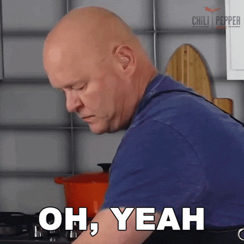 a bald man in a blue shirt says oh yeah in a kitchen