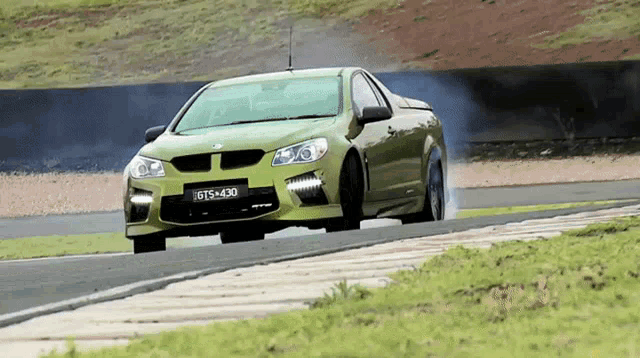 a green sports car with the license plate gts-430