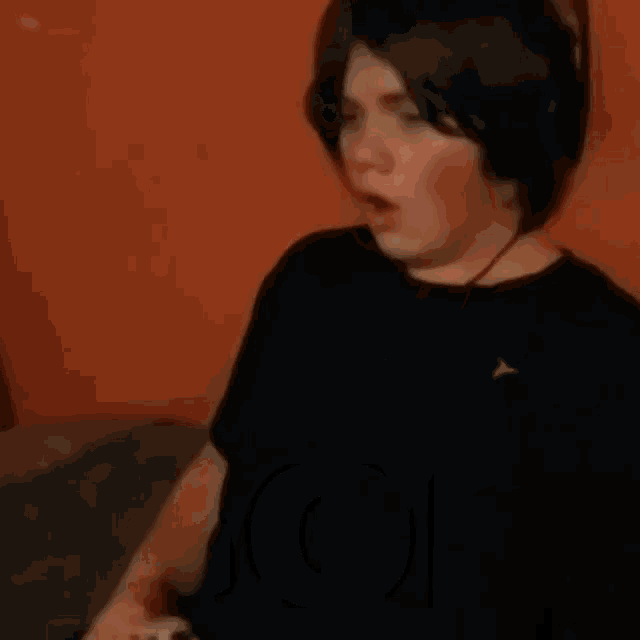 a boy wearing headphones is making a funny face with the word my in front of his face
