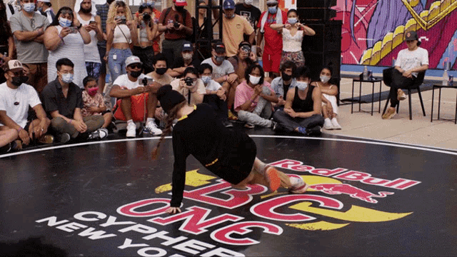 a group of people are gathered around a dance floor that says red bull cypher new york on it
