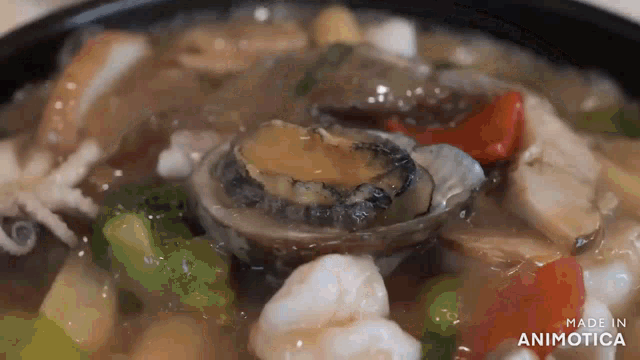 a close up of a seafood dish with the words made in animotica visible