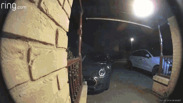 a ring.com camera shows a car parked in front of a brick building