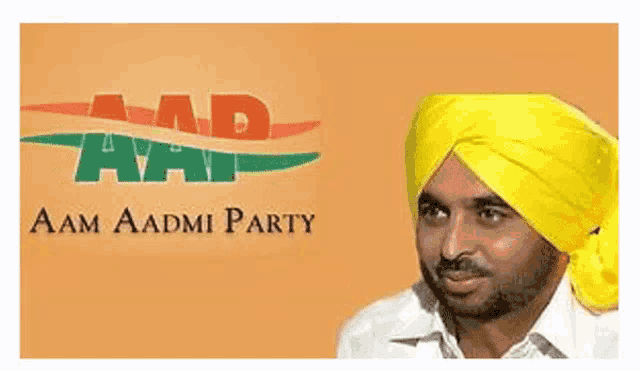 a man wearing a yellow turban stands in front of an aam aadmi party sign